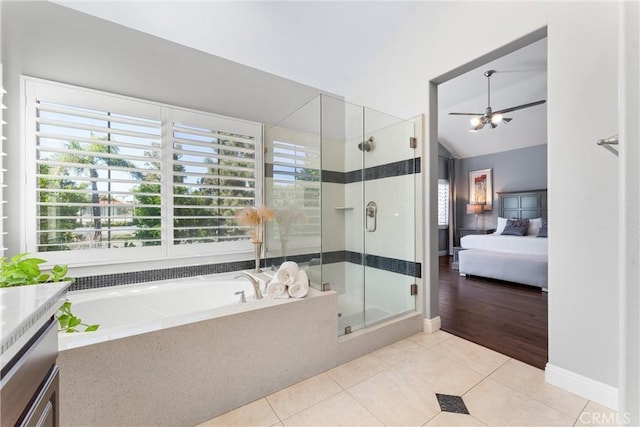 bathroom with a stall shower, a healthy amount of sunlight, ensuite bath, and a garden tub
