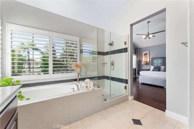 12475 Woodhall Way, Tustin, CA 92782 - ensuite bathroom featuring plenty of natural light, a stall shower, a garden tub, tile patterned flooring, and vaulted ceiling