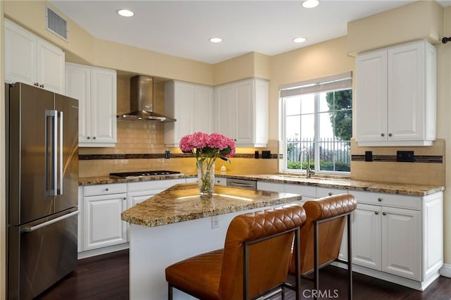 608 Chaparral Ct, Altadena, CA 91001 - kitchen featuring visible vents, dark wood-type flooring, wall chimney exhaust hood, a sink, and appliances with stainless steel finishes