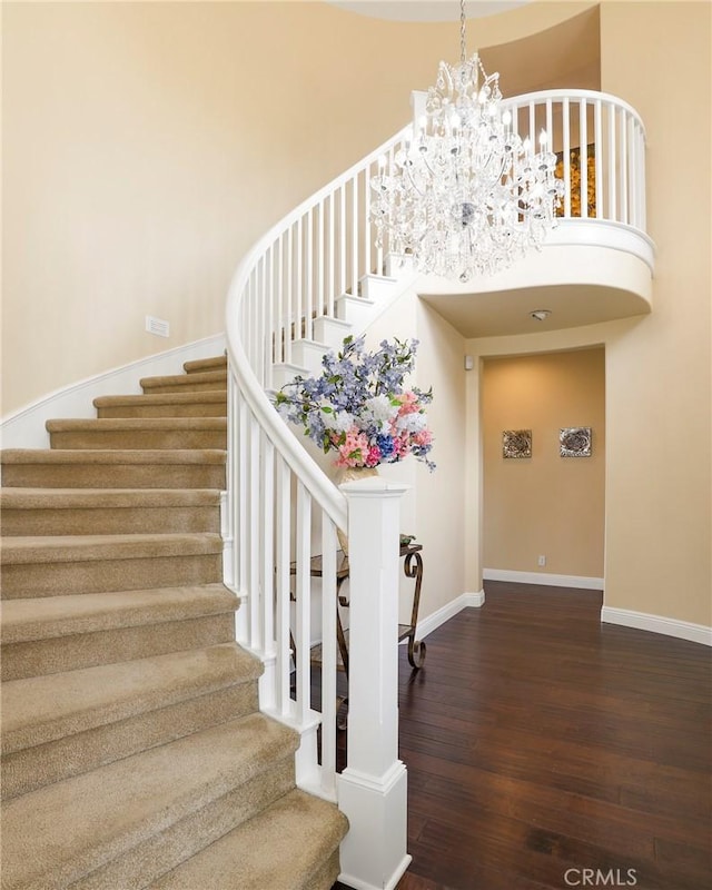 608 Chaparral Ct, Altadena, CA 91001 - stairway with baseboards, a high ceiling, wood finished floors, and an inviting chandelier