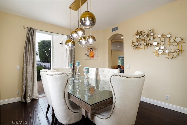 608 Chaparral Ct, Altadena, CA 91001 - dining space featuring arched walkways, baseboards, visible vents, and dark wood-type flooring