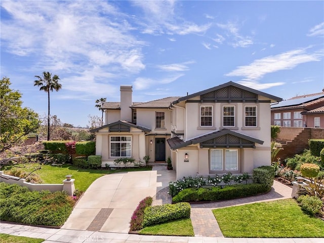 608 Chaparral Ct, Altadena, CA 91001 - view of front facade featuring fence, a front yard, stucco siding, a chimney, and driveway
