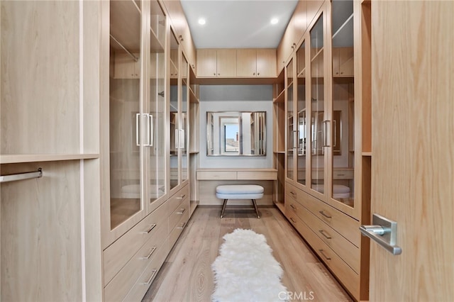 spacious closet featuring light wood-style flooring