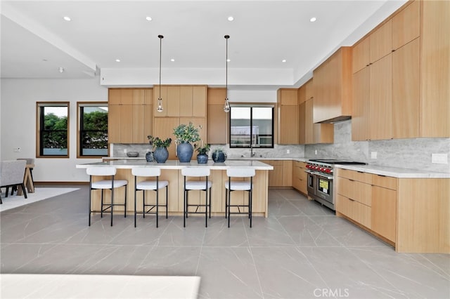 kitchen with modern cabinets, marble finish floor, a breakfast bar area, and double oven range