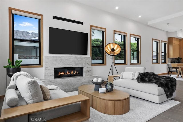 living room with a premium fireplace, a wealth of natural light, and recessed lighting