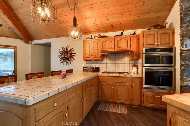 40957 Shandee Ln, Ahwahnee, CA 93601 - kitchen with tasteful backsplash, wood ceiling, vaulted ceiling with beams, and stainless steel double oven