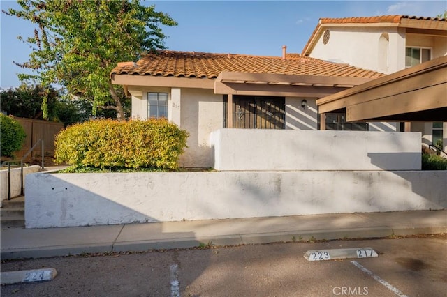 1651 S Juniper Unit 217, Escondido, CA 92025 - mediterranean / spanish home featuring a tile roof, stucco siding, and uncovered parking