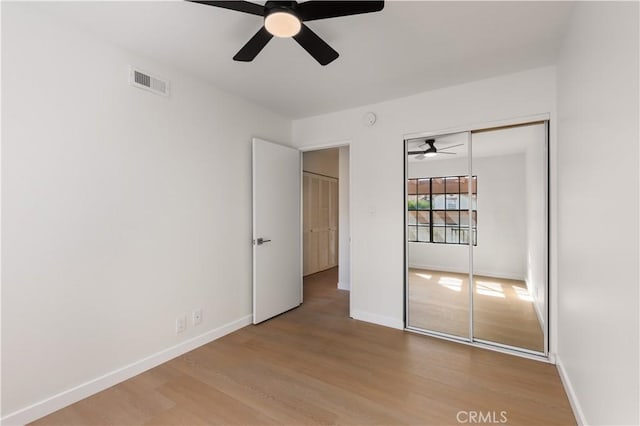 1651 S Juniper Unit 217, Escondido, CA 92025 - unfurnished bedroom with wood finished floors, baseboards, a closet, and a ceiling fan