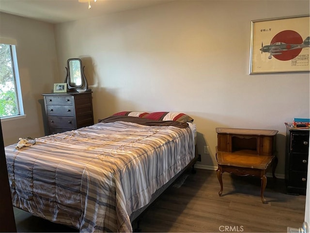 bedroom with wood finished floors and baseboards