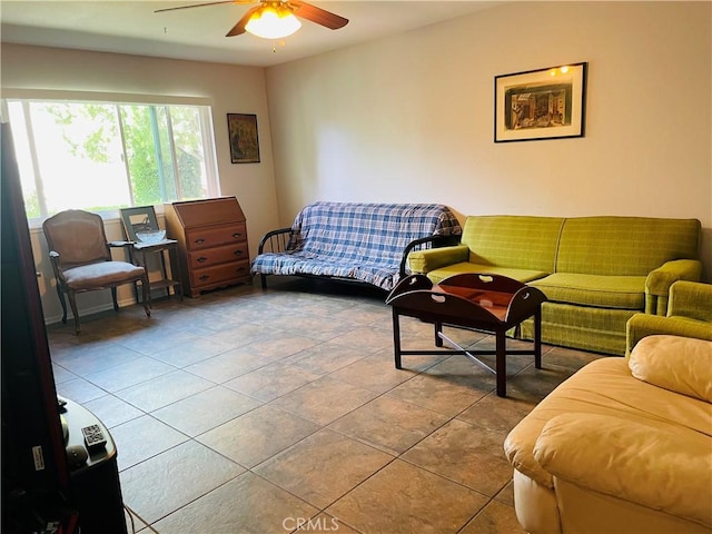 living room with a ceiling fan and tile patterned flooring