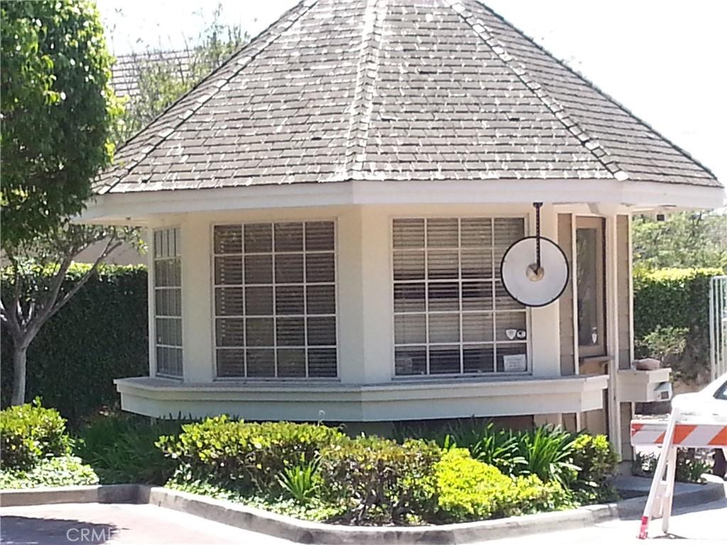 view of home's exterior with a gazebo, a shingled roof, and stucco siding