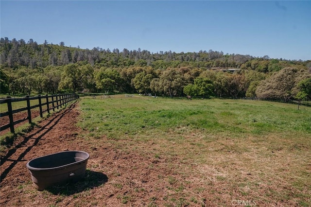 14134 Serpentine Farm Ln, Grass Valley, CA 95949 - view of yard featuring a wooded view, fence, and a rural view