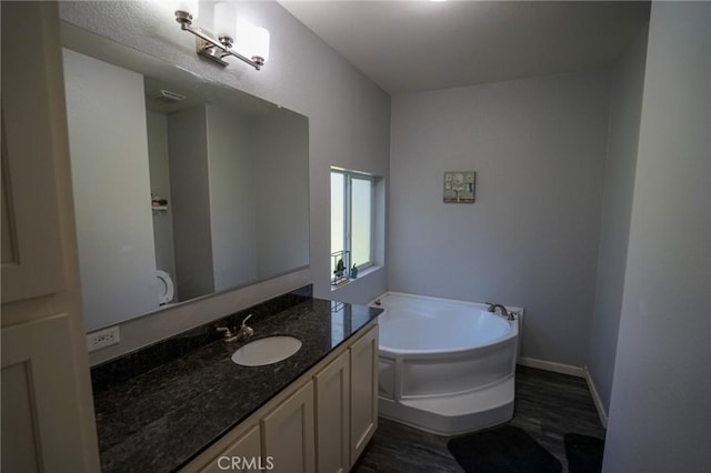 14134 Serpentine Farm Ln, Grass Valley, CA 95949 - full bath featuring a bath, wood finished floors, vanity, and baseboards
