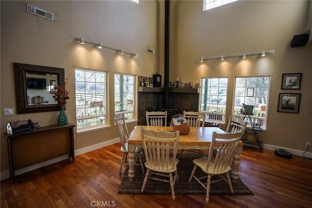 14134 Serpentine Farm Ln, Grass Valley, CA 95949 - dining space featuring visible vents, baseboards, a towering ceiling, wood-type flooring, and rail lighting