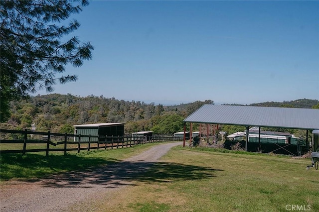 14134 Serpentine Farm Ln, Grass Valley, CA 95949 - view of yard featuring an exterior structure, a view of trees, and an outdoor structure