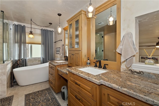 1376 St Anton Dr, Lake Arrowhead, CA 92352 - full bathroom featuring two vanities, walk in shower, visible vents, a freestanding bath, and a sink