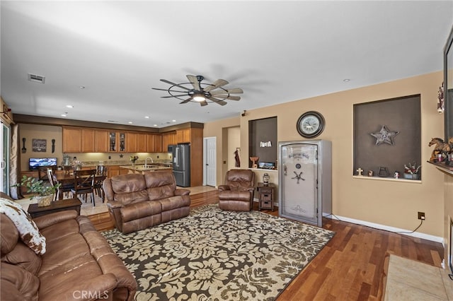 living area featuring visible vents, baseboards, recessed lighting, a ceiling fan, and wood finished floors