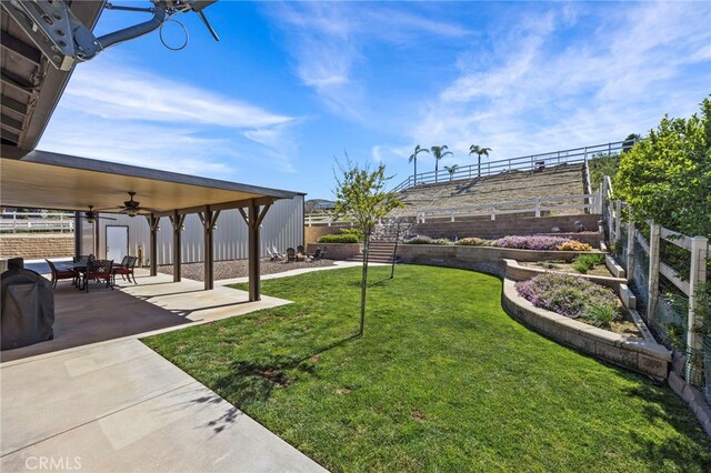 view of yard featuring ceiling fan, a fenced backyard, and a patio area