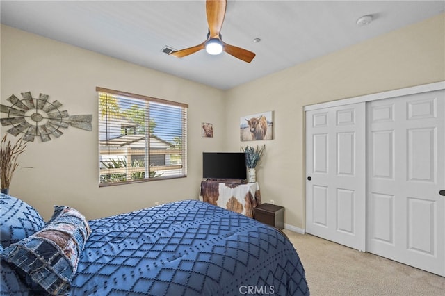 carpeted bedroom with baseboards, a ceiling fan, visible vents, and a closet