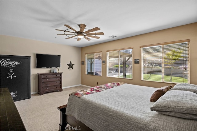 bedroom with baseboards, a ceiling fan, carpet flooring, and visible vents