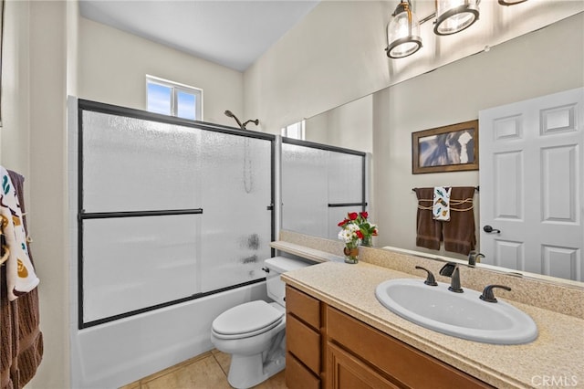 full bathroom featuring shower / bath combination with glass door, tile patterned flooring, toilet, and vanity
