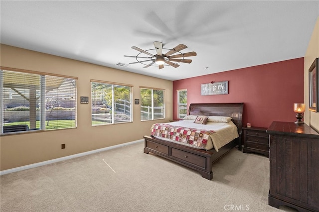 carpeted bedroom featuring visible vents, baseboards, and ceiling fan