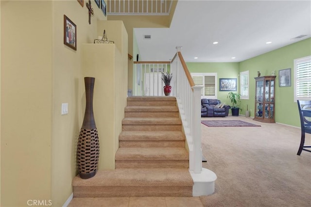 staircase featuring recessed lighting, baseboards, visible vents, and carpet floors