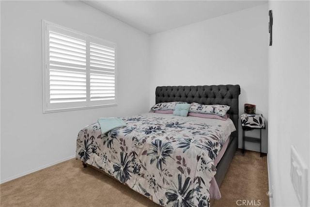 carpeted bedroom featuring baseboards