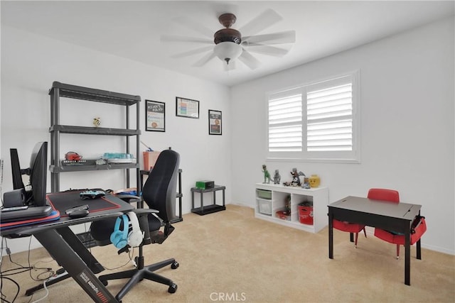 home office featuring carpet floors, ceiling fan, and baseboards