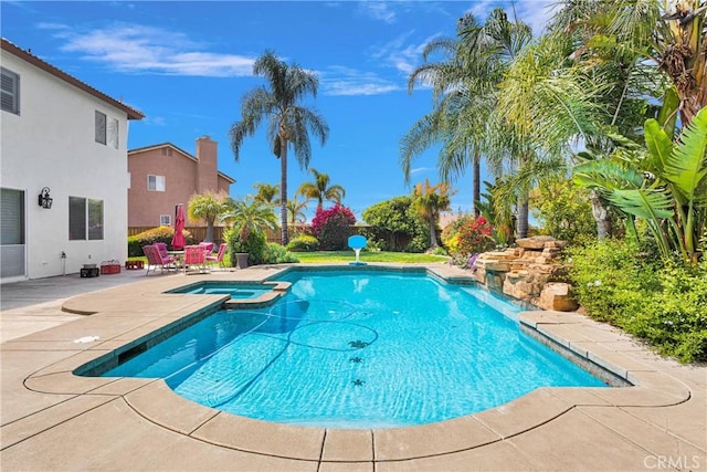 view of pool featuring a patio area and a pool with connected hot tub