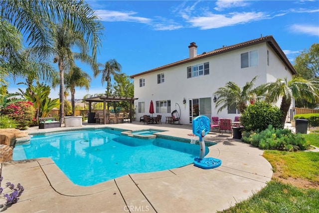 view of swimming pool featuring a patio, outdoor dry bar, a pergola, and a pool with connected hot tub