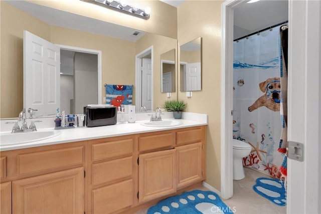bathroom with a sink, toilet, double vanity, and curtained shower