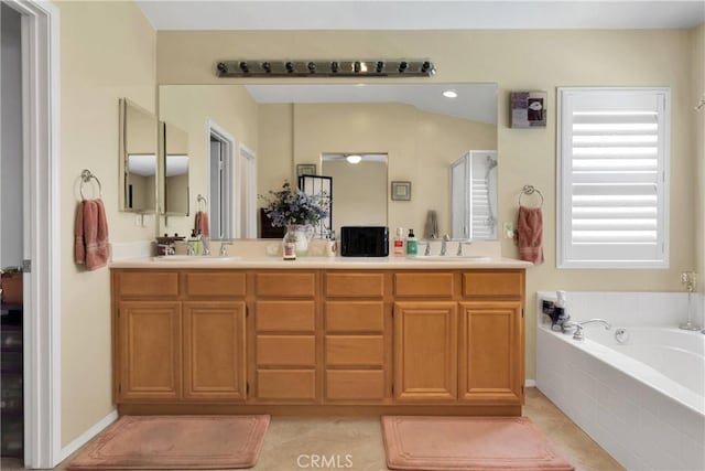 bathroom featuring a bath, tile patterned floors, and double vanity