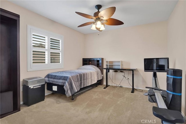 carpeted bedroom with baseboards and a ceiling fan