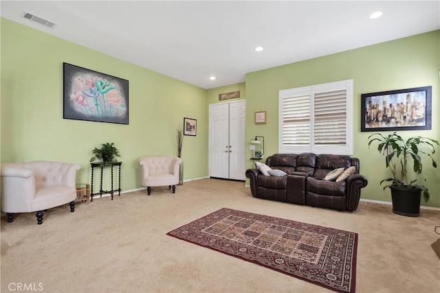 carpeted living area with visible vents, baseboards, and recessed lighting