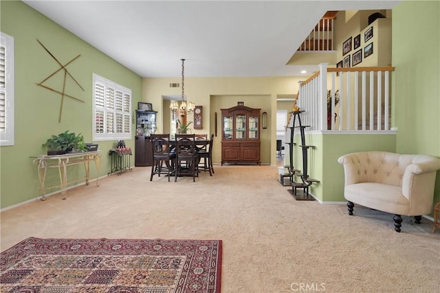 interior space with carpet flooring, a notable chandelier, and baseboards