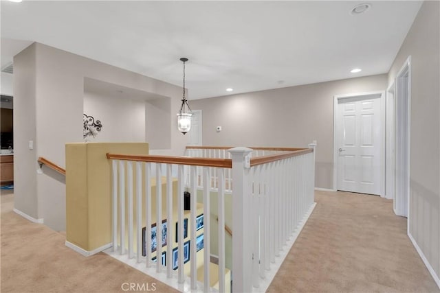 hall with light carpet, recessed lighting, an upstairs landing, and baseboards