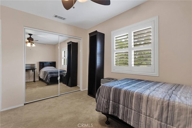 bedroom with visible vents, baseboards, a closet, and carpet