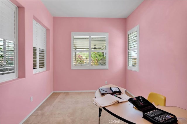 carpeted home office featuring baseboards