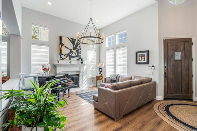 living area featuring a notable chandelier, plenty of natural light, and wood finished floors