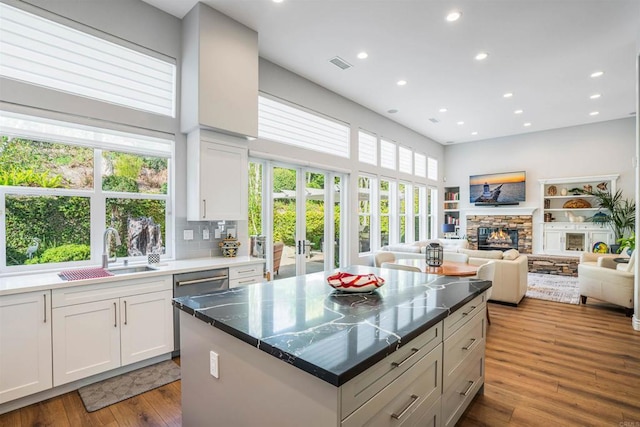 kitchen featuring visible vents, recessed lighting, white cabinetry, french doors, and a sink