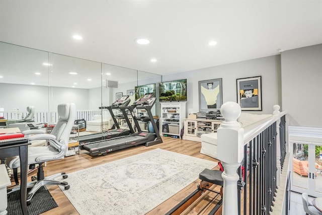 workout area featuring recessed lighting, visible vents, and light wood-style floors