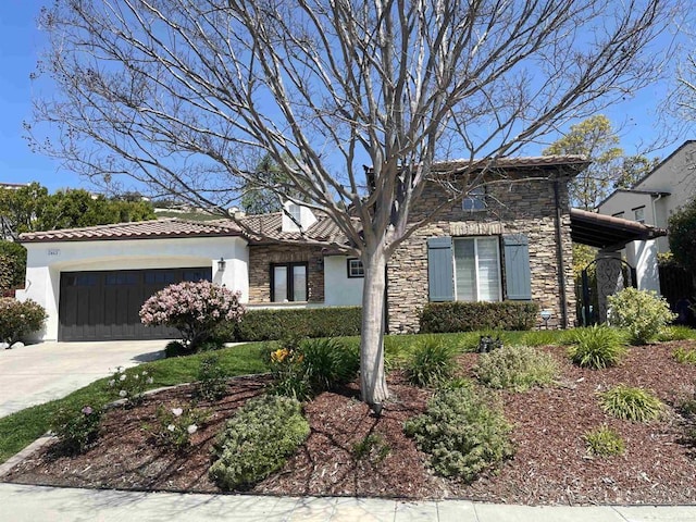view of front of home with stone siding, a garage, stucco siding, a tiled roof, and driveway