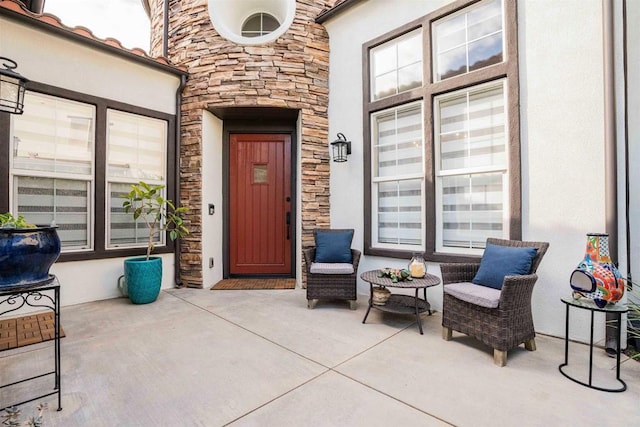property entrance with stone siding and stucco siding