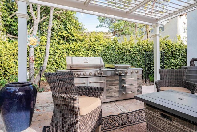 view of patio with a grill, a pergola, and an outdoor kitchen