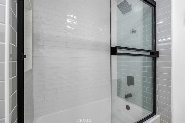 bathroom featuring shower / bath combination with glass door