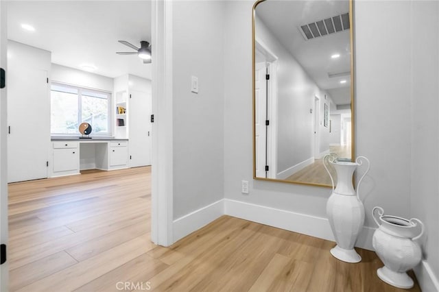 corridor with visible vents, baseboards, light wood finished floors, and recessed lighting