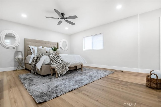 bedroom with recessed lighting, baseboards, and wood finished floors