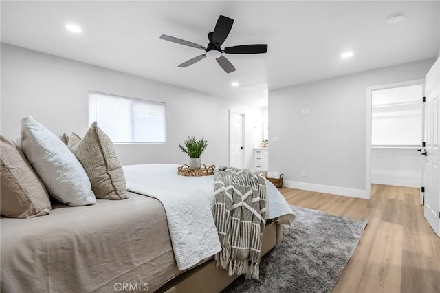 bedroom with recessed lighting, light wood-style floors, baseboards, and a ceiling fan