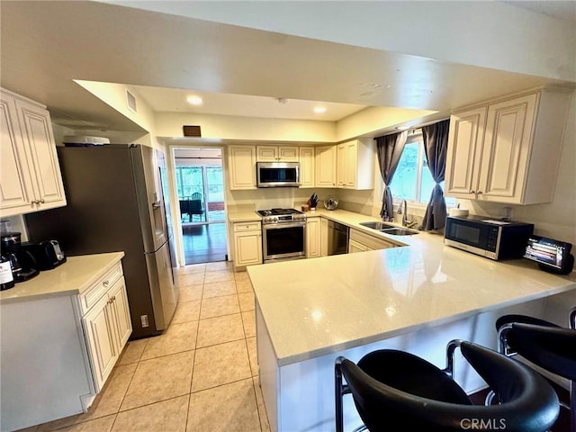 2842 Pietro Dr, Hacienda Heights, CA 91745 - kitchen with stainless steel appliances, a sink, a peninsula, light countertops, and light tile patterned flooring